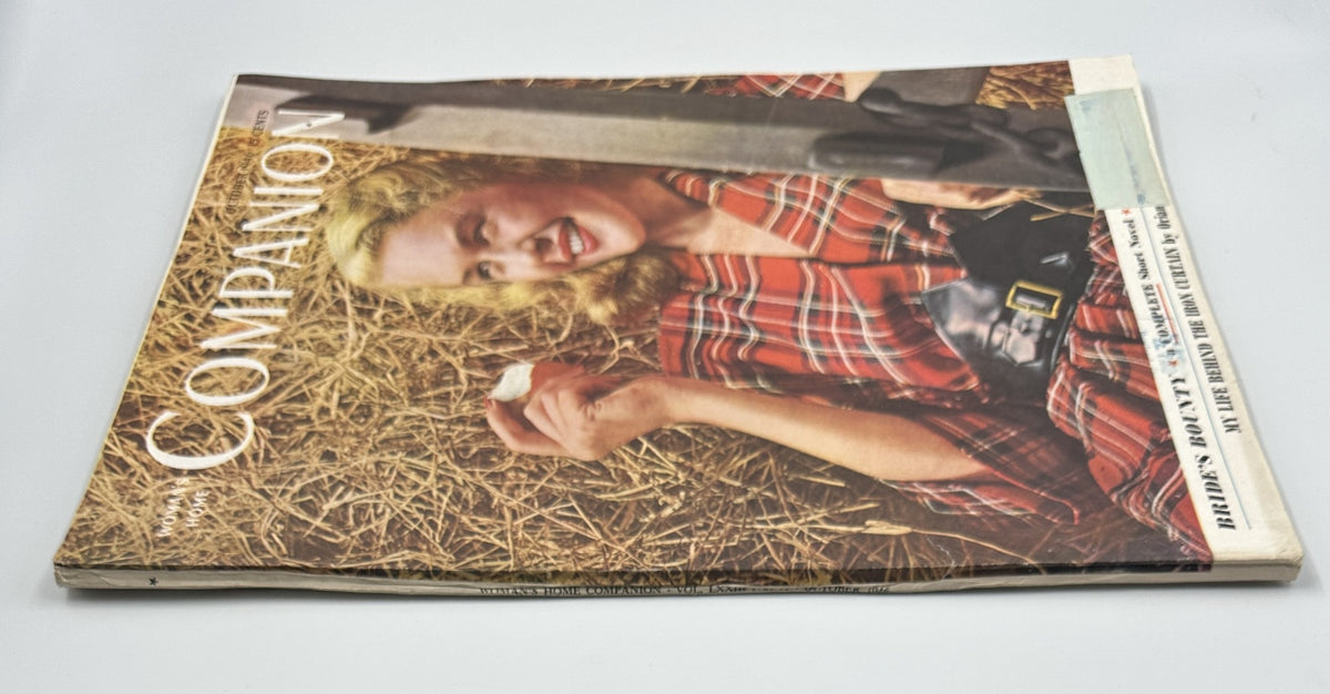 Side view of the Woman's Home Companion Magazine from October 1946, featuring information on 'Bride's Bounty'. The image captures the magazine's spine and front cover, showcasing the smiling woman in a plaid dress.