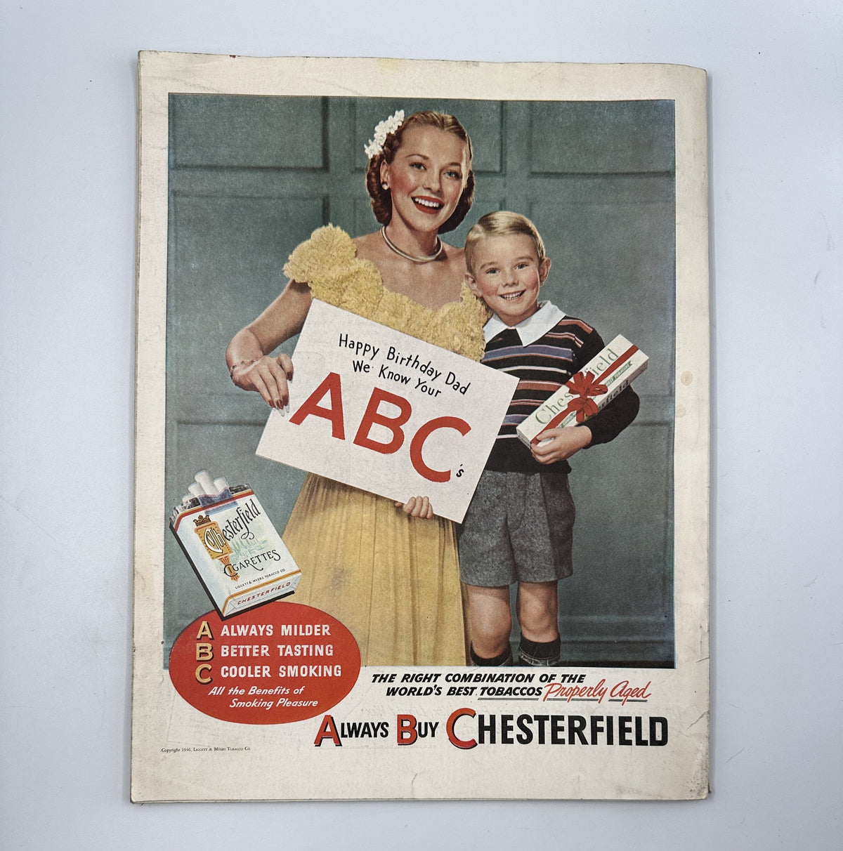 Back cover of Woman’s Home Companion Magazine April 1946 featuring a cheerful girl and boy celebrating a birthday, promoting Chesterfield cigarettes.