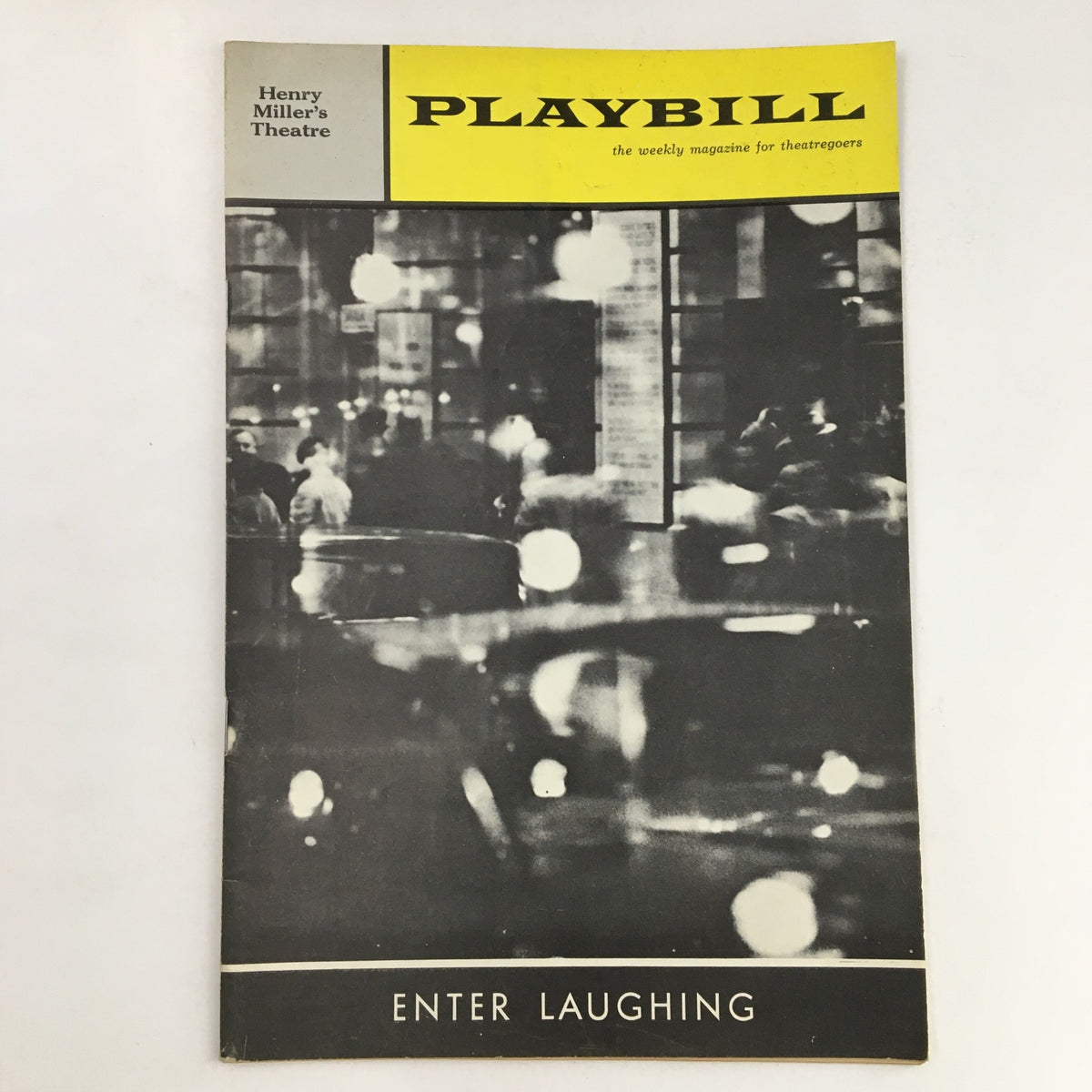 1963 Playbill Henry Miller's Theatre featuring Enter Laughing, showcasing a vintage black and white photograph of a bustling New York City street.