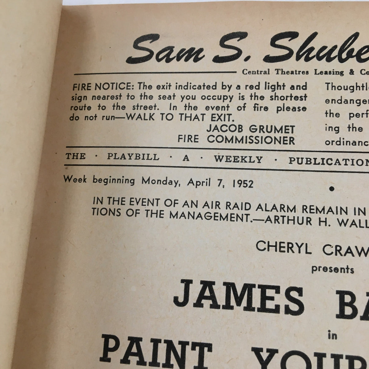 Close-up view of the 1952 Playbill from Sam S. Shubert Theatre, emphasizing production notes for Paint Your Wagon, including the fire safety notice and details about the performance week.