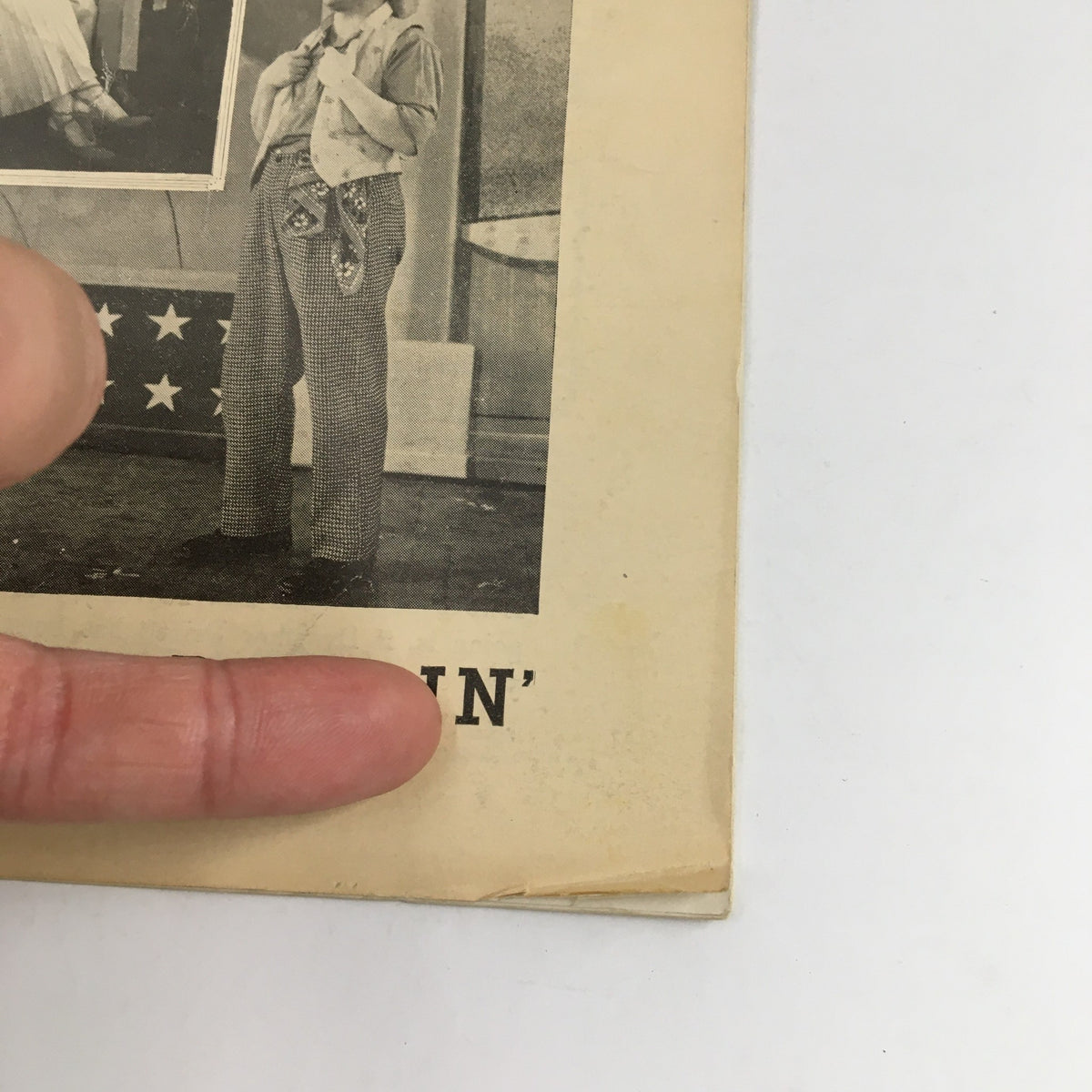 Close-up view of the 1949 Playbill for Texas, Lil' Darlin', displaying details of the vintage design and creases representing its history.