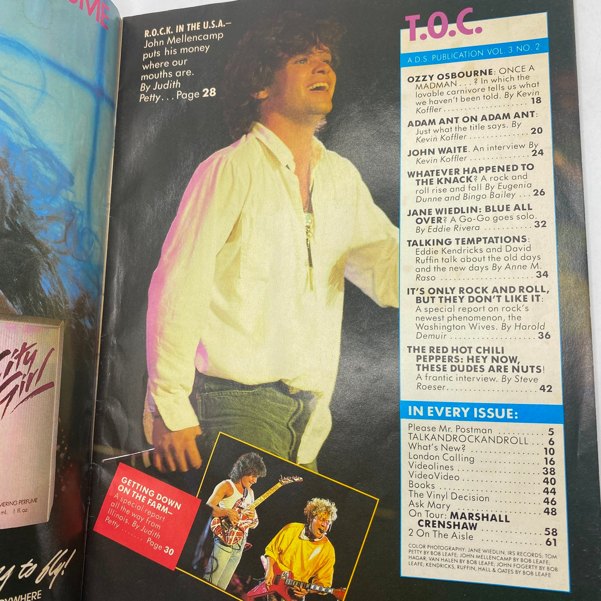 Inside page from January 1986 issue of Tiger Beat magazine showcasing a concert performance by John Mellencamp with an article list including 'Jane Wiedlin: Blue All Over'.