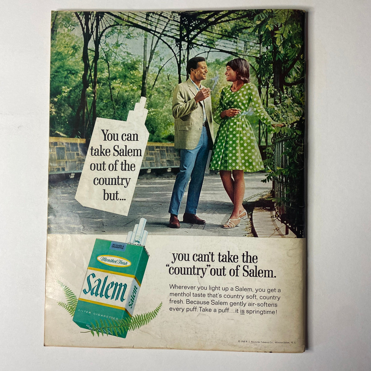Ebony Magazine September 1968 advertisement illustration featuring a couple in vintage attire, promoting Salem cigarettes with the tagline about the country freshness and style, framed in a lush garden setting.