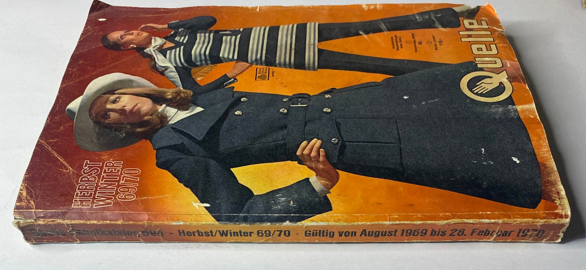 1969 - 1970 Quelle Winter Catalog with a worn cover showcasing a model in a navy coat and another in a striped dress, highlighting German fashion trends.
