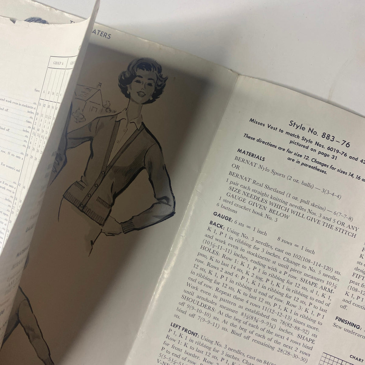 Close-up of the 1959 Bernat Handicraft Bulky Knits Catalog showing a woman in a knitted cardigan, emphasizing the pattern materials and gauge instructions.