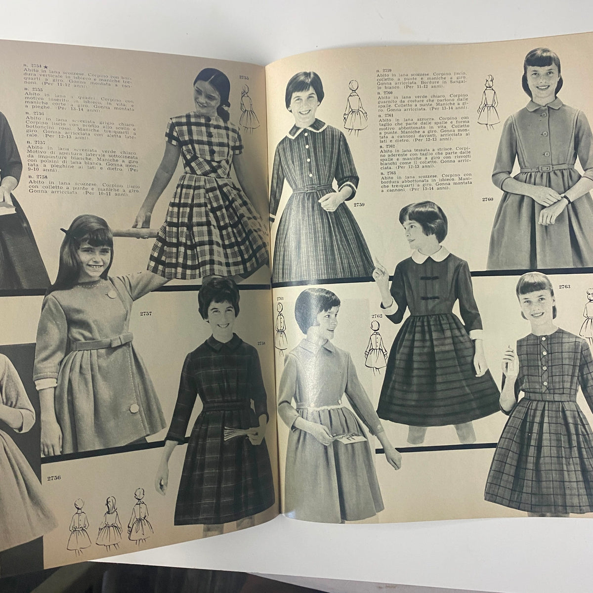 1962 La Moda Dei Bimbi Autumn and Winter Catalog displaying young girls in classic mid-century dresses. The layout features several styles in a mix of patterns, focusing on vintage children's fashion.