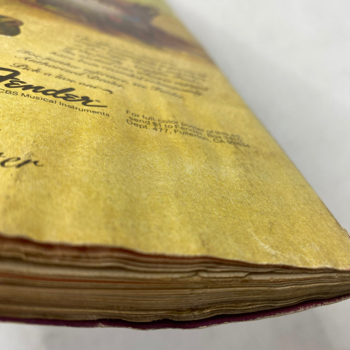 Close-up view of the side edge of VTG Guitar Player Magazine May 1977, showing wear and vintage appeal, highlighting its collectible nature.