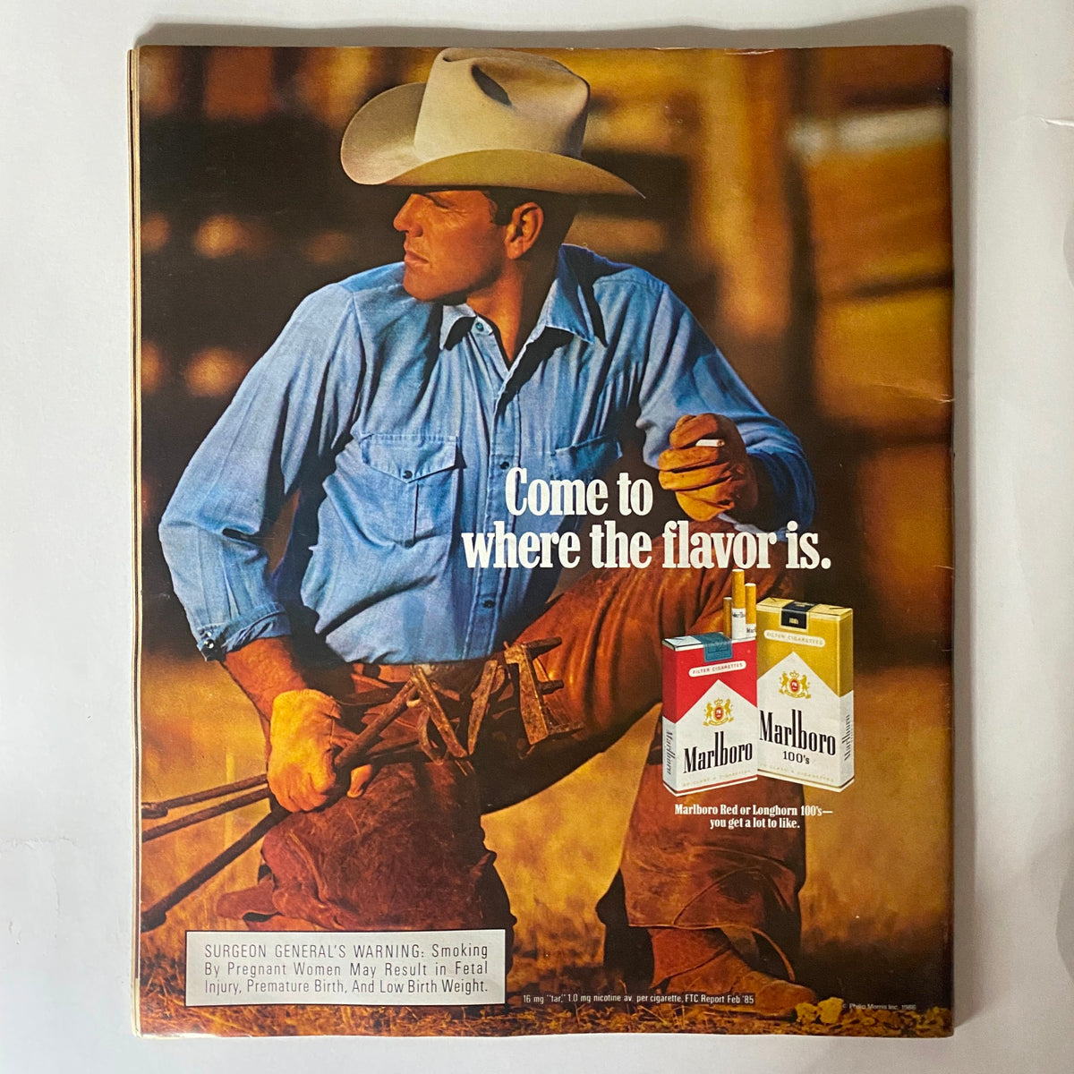 Back cover of a vintage magazine featuring a Marlboro advertisement with a cowboy, emphasizing the slogan 'Come to where the flavor is,' illustrating the commercial culture of the 1980s.