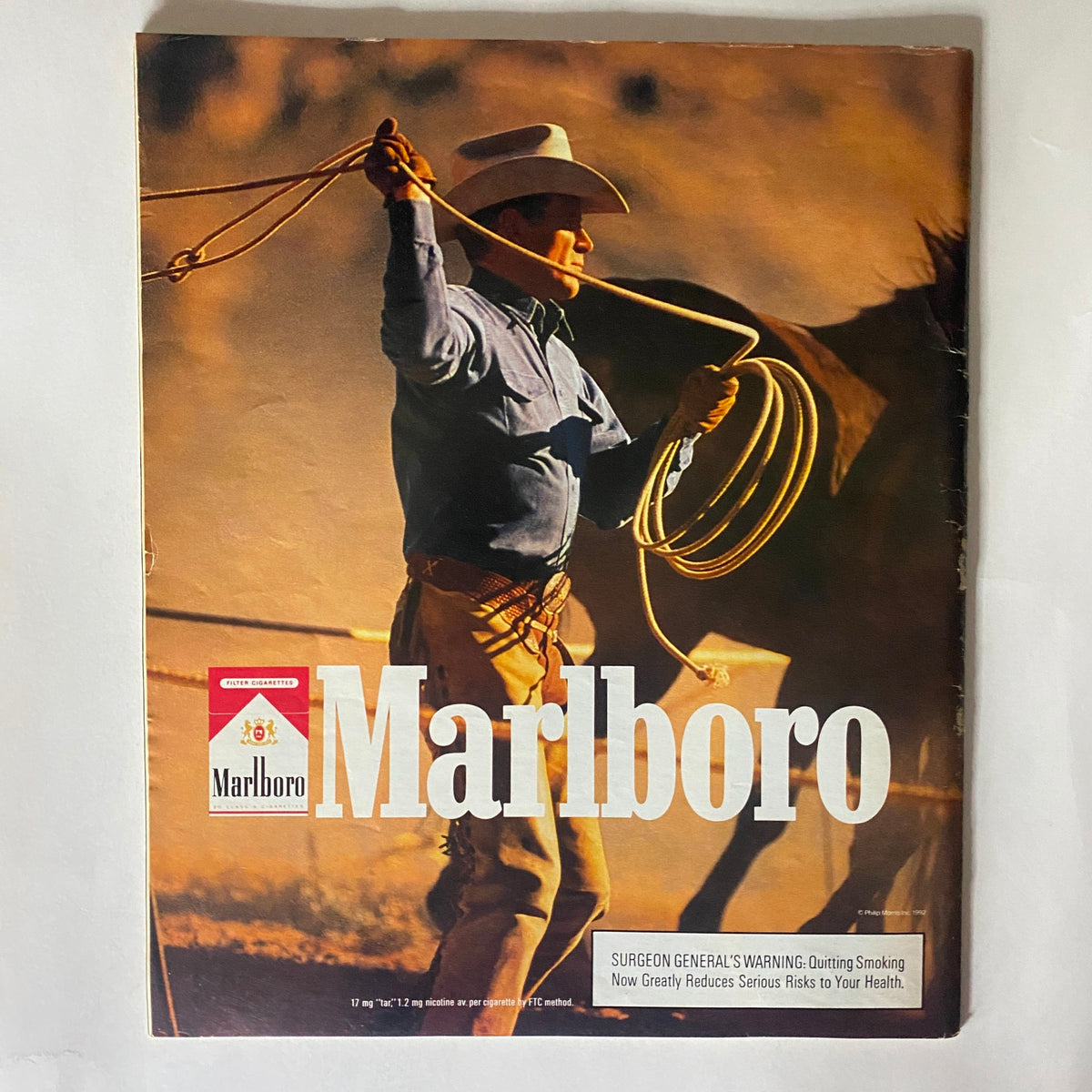 Vintage Marlboro magazine advertisement featuring a cowboy roping, illustrating the classic Americana aesthetic, complemented by the magazine's title.