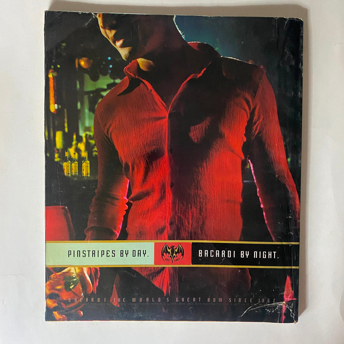 Back cover of the July 1998 Spin Magazine featuring a promotional graphic for Bacardi rum, showcasing vibrant nightlife themes.