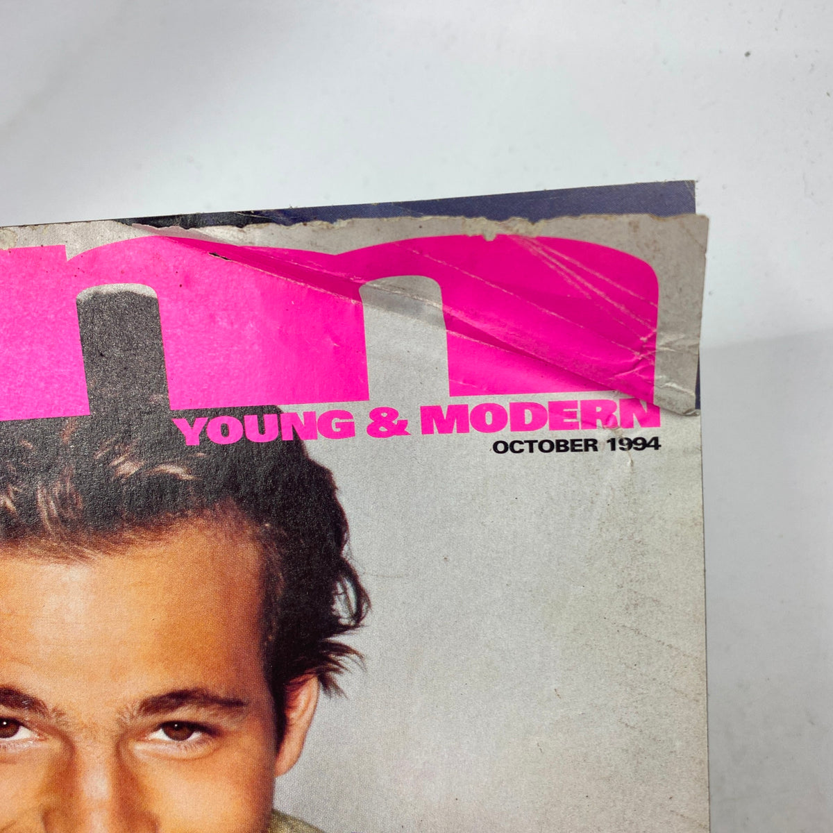 Close-up of the top section of YM Young & Modern Magazine October 1994, showcasing the logo and issue date along with the featured star.