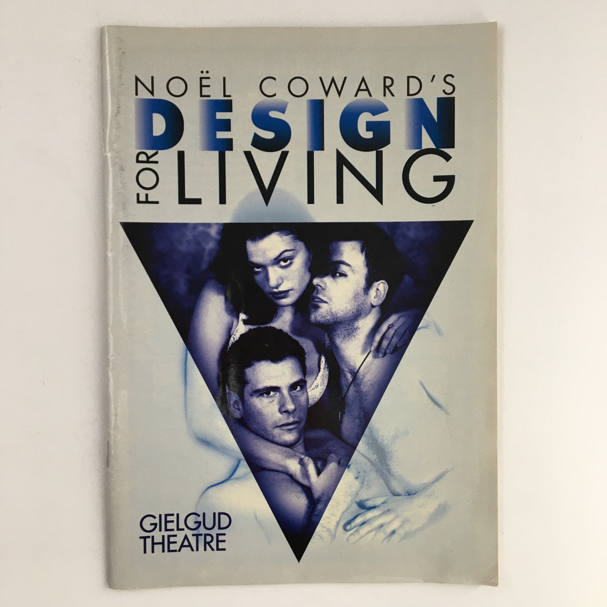 Cover of 1995 A Stoll Moss Theatre Gielgud Theatre Present Noel Coward's Design for Living featuring three actors in a dramatic pose against a blue triangle background.
