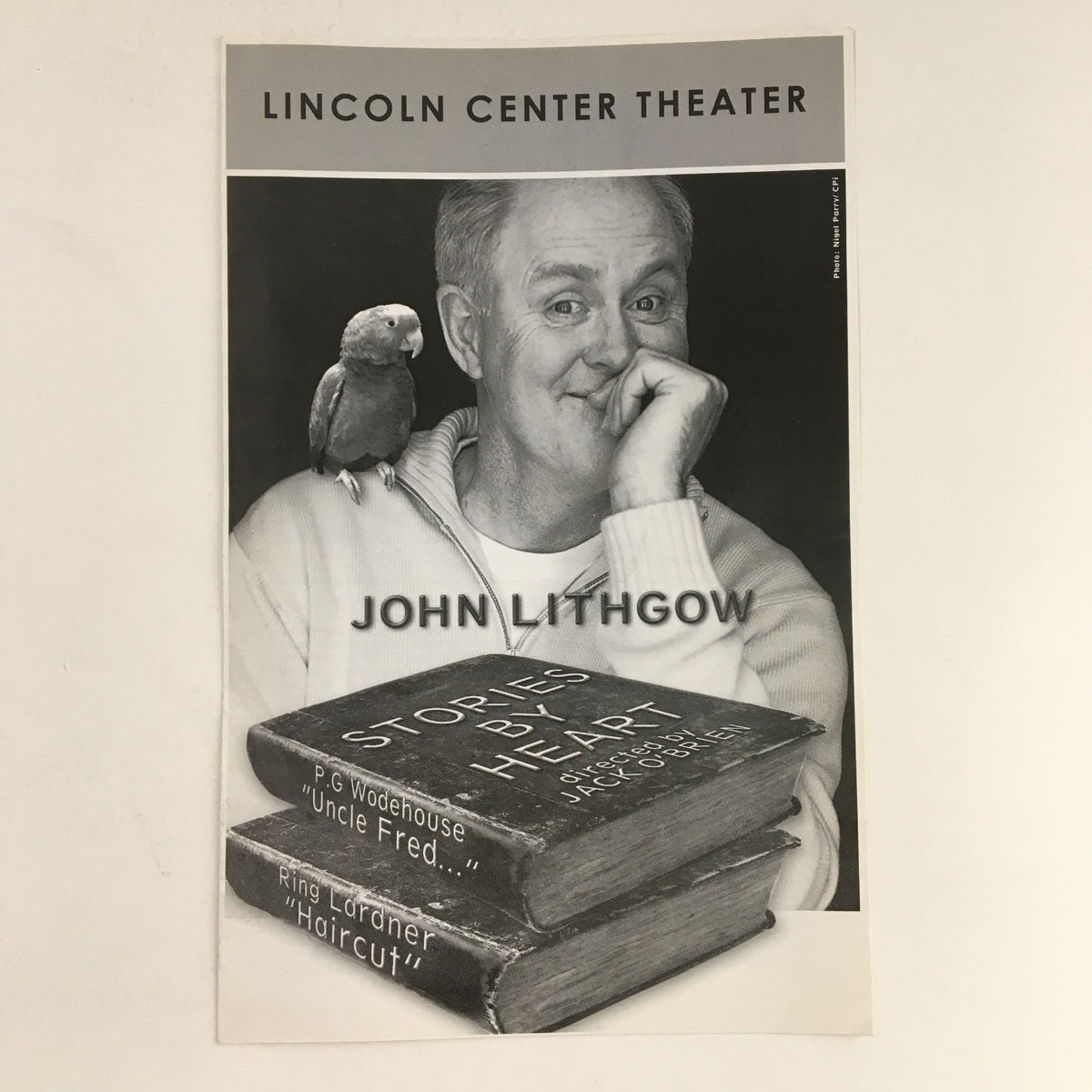 Cover of the program for '2009 The Front Page' Broadway production at Lincoln Center Theater featuring John Lithgow with a parrot on his shoulder and books stacked below.