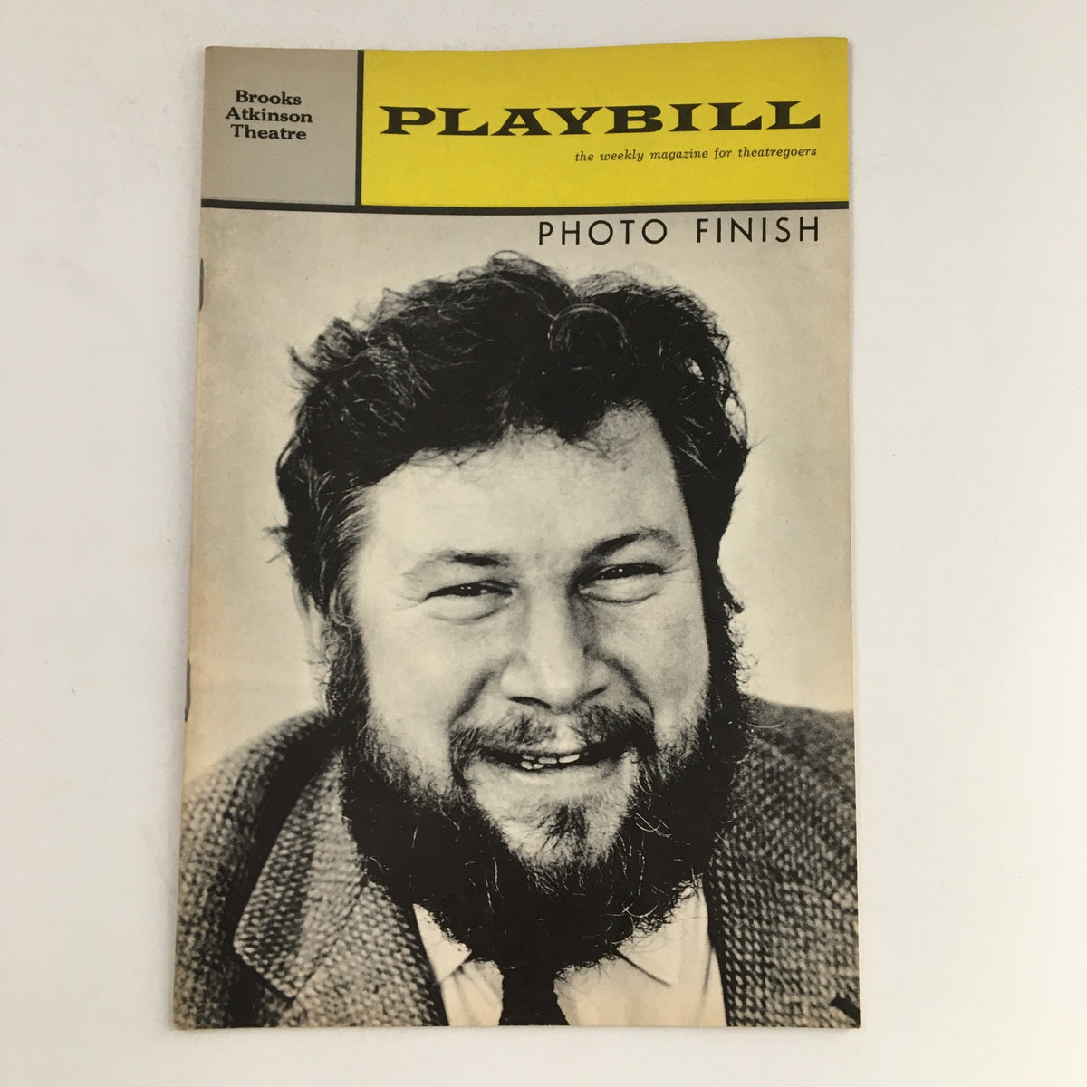 1963 Playbill for Photo Finish featuring a black and white portrait of Peter Ustinov, highlighting his familiar smile and signature beard, encapsulating the charm of vintage theater.