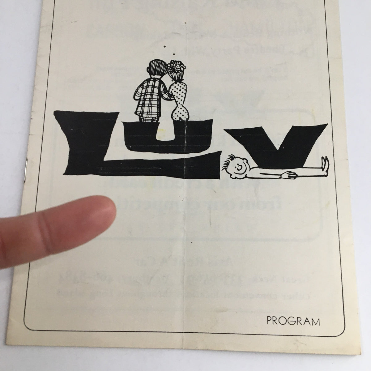 Close-up of the 1967 Mineola Theatre Program for "Luv" by Murray Schisgal, highlighting an illustration of characters and the playful program title.