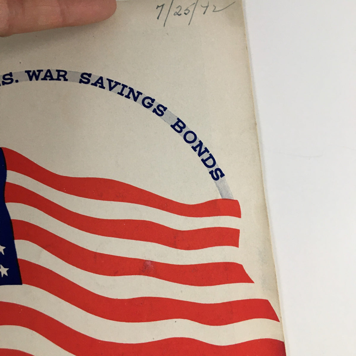 Detailed view of the cover of the 1942 Playbill for This Is The Army, emphasizing the patriotic design and promotional message for U.S. War Savings Bonds.