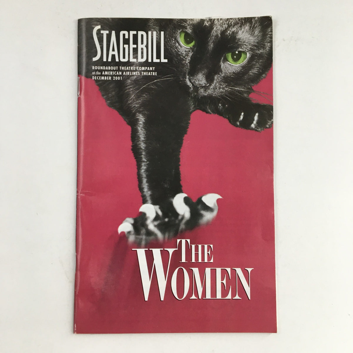 Cover of the 2001 Stagebill for Roundabout Theatre Company, featuring a dramatic image of a cat with green eyes, promoting Clare Boothe Luce's The Women.