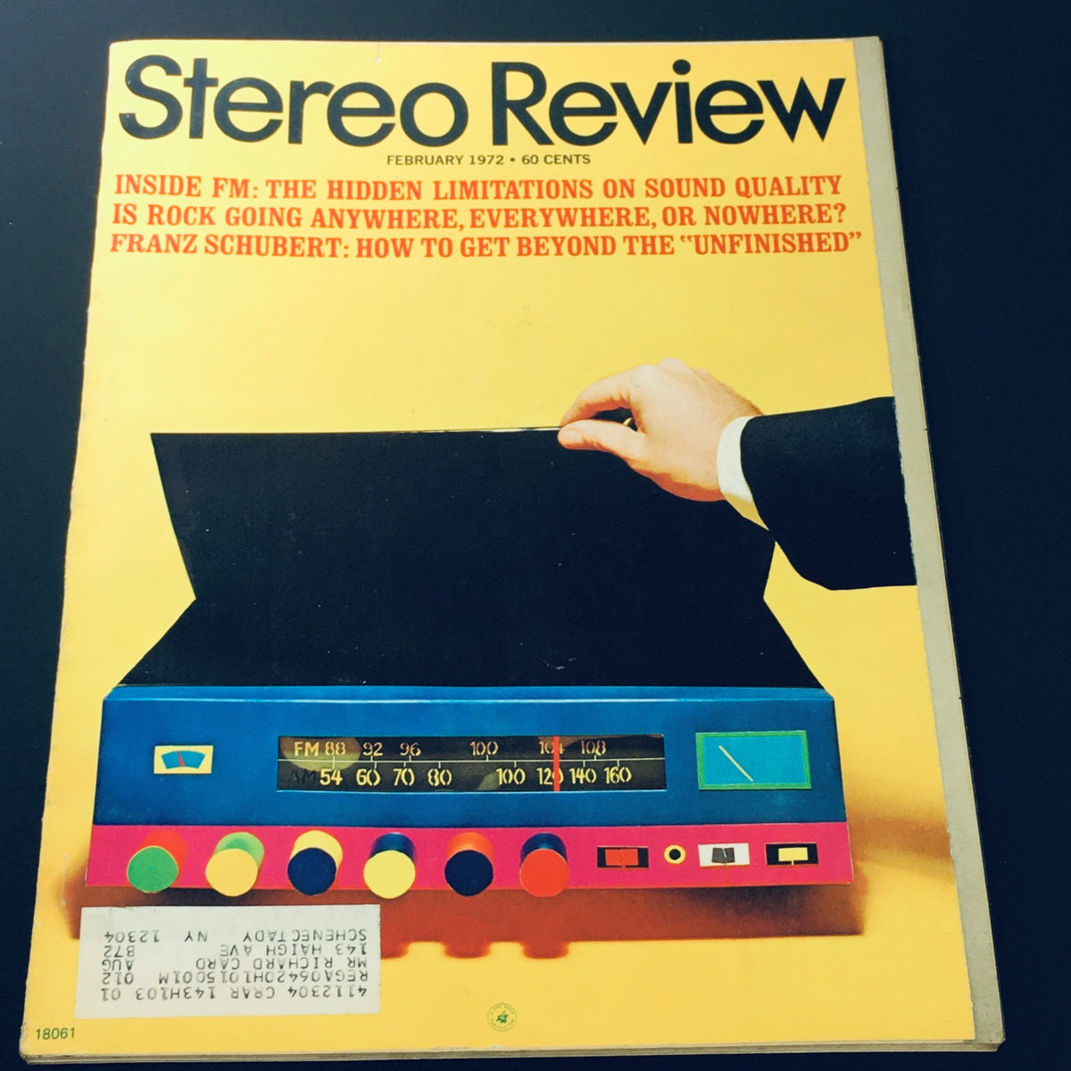 Cover of the Stereo Review Magazine, February 1972 - Featuring Franz Schubert's 'Unfinished' Symphony, showcasing a colorful stereo system with a hand reaching toward a music player, highlighting the era's sound technology and music culture.