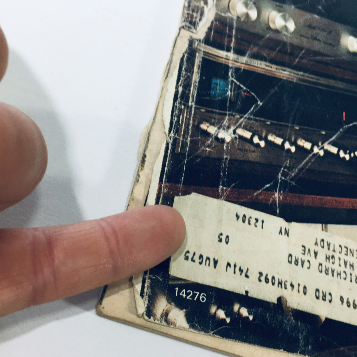 Close-up of a page from the VTG Stereo Review Magazine May 1975, featuring a hand pointing to a worn label and an image of amplifier components, highlighting the vintage audio technology discussed in the issue.