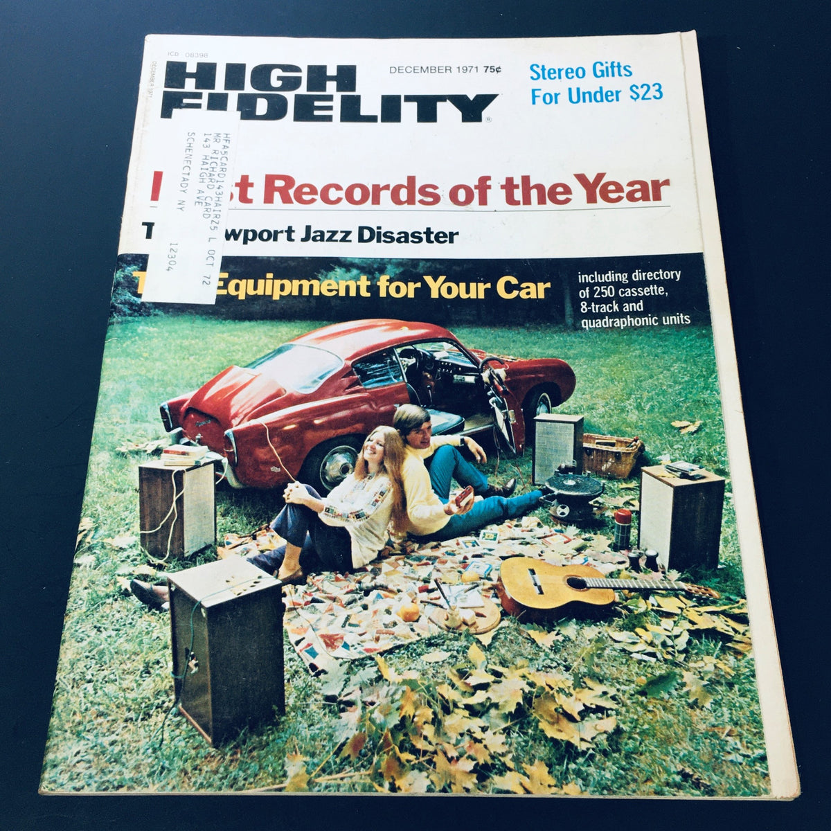 Cover of VTG High Fidelity Magazine December 1971 featuring articles on Jazz Disaster and car stereo equipment, showcasing a couple sitting on the grass surrounded by audio gear and a classic red car.