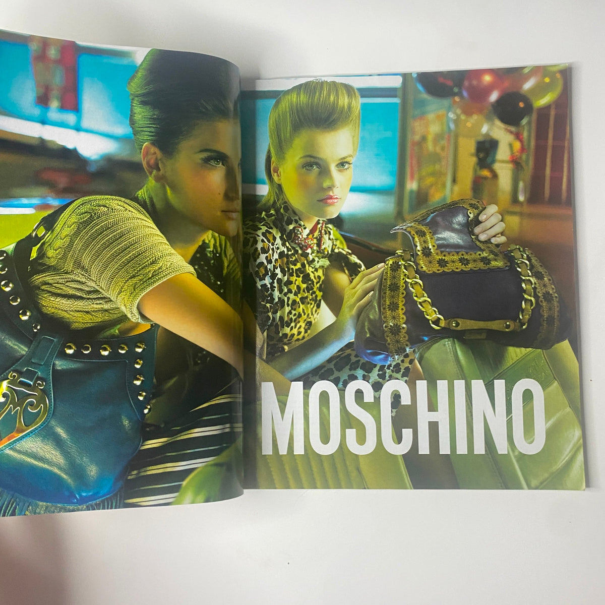 2006 Elle Accessories Spring Catalog showing a stylish model wearing Moschino fashion with vibrant colors and unique accessories, emphasizing contemporary spring trends.