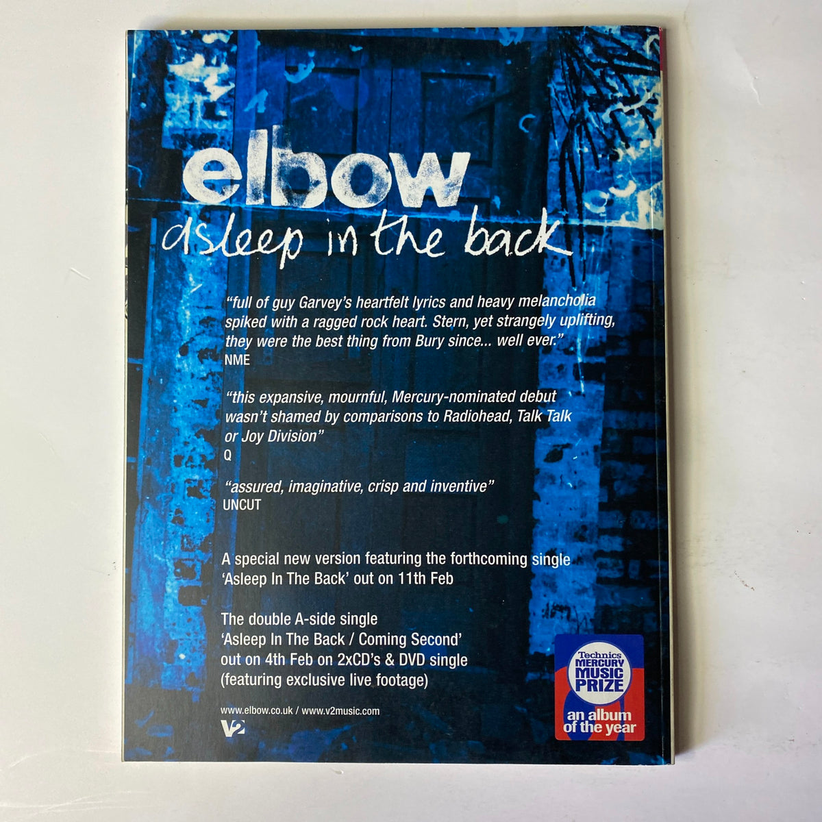 Back cover of 'Asleep in the Back' by Elbow featuring insightful reviews and album details. Part of the Mojo Music Magazine February 2002 edition with Brian Wilson on the cover.