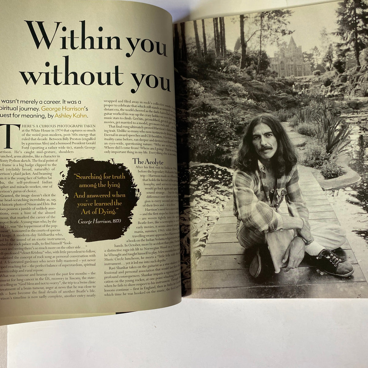 Page from Mojo Music Magazine January 2002 highlighting an article discussing George Harrison with a serene background image of him in a garden.
