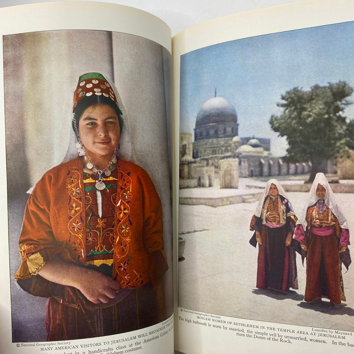 National Geographic Magazine December 1927 featuring a color photograph of women in traditional dress, highlighting cultural attire from Jerusalem, as part of the article 'The Pageant of Jerusalem'.