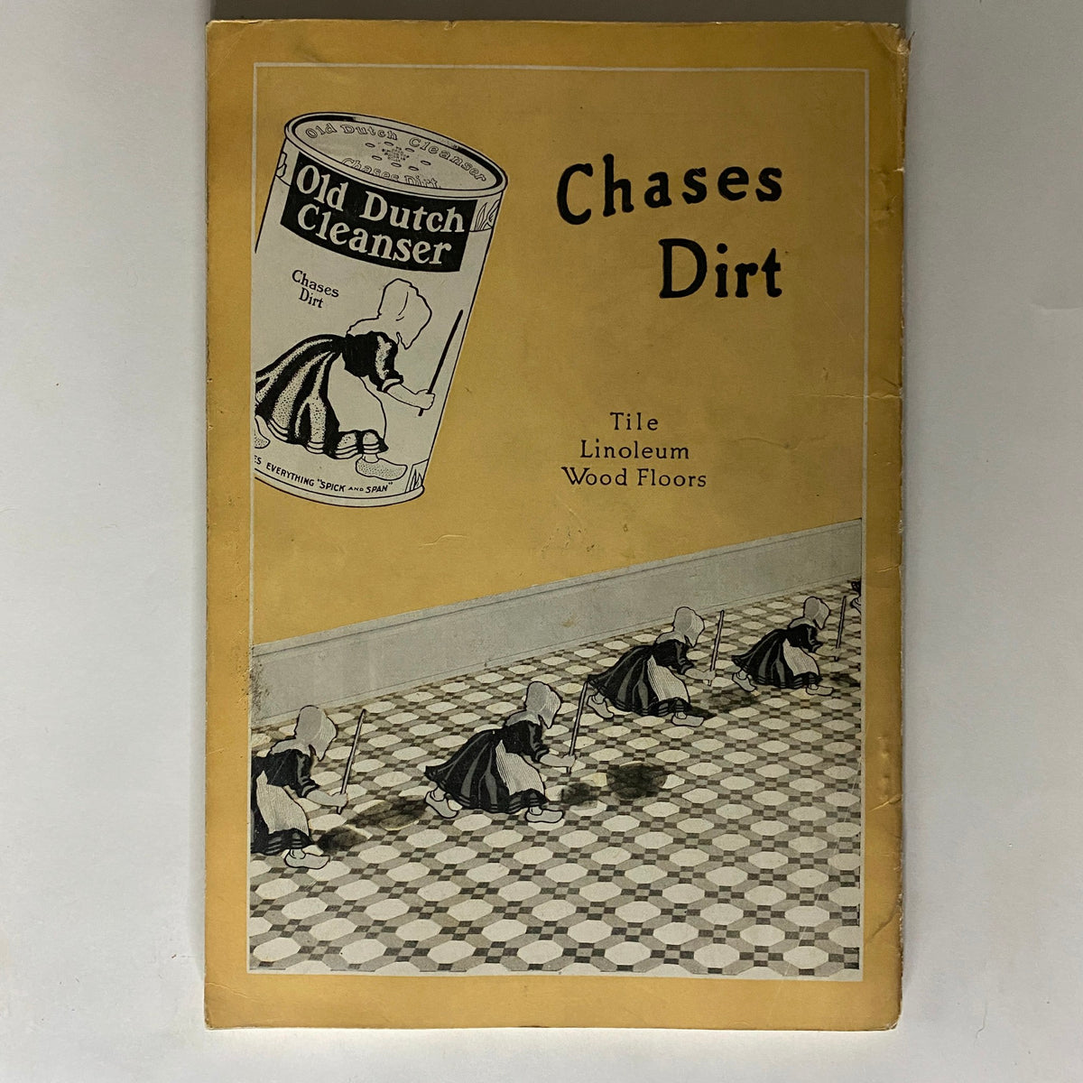 Cover of the vintage publication 'Old Dutch Cleanser' illustrating a product advertisement with playful imagery of cleaning figures on tiled floors.