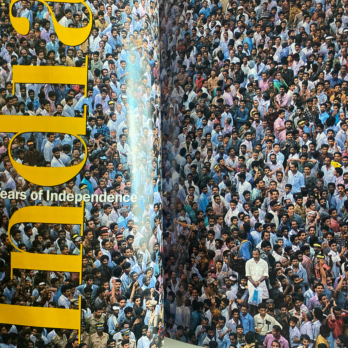 Inside spread of the National Geographic Magazine May 1997 showcasing a large crowd, symbolizing the diversity and unity of India. The page emphasizes 'India: 50 Years of Independence' alongside a vibrant visual representation of the people.