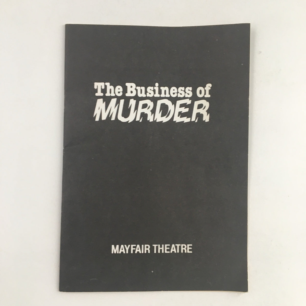 Cover of the 1981 Mayfair Theatre program for 'The Business of Murder' by Richard Harris, featuring bold text and minimalist design in black and white.