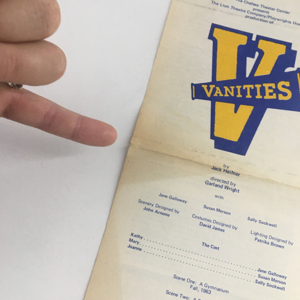 Cover page of 1976 The Chelsea Theater Present Vanities by G. Wright featuring the play title in bold yellow lettering and a finger pointing to the title.