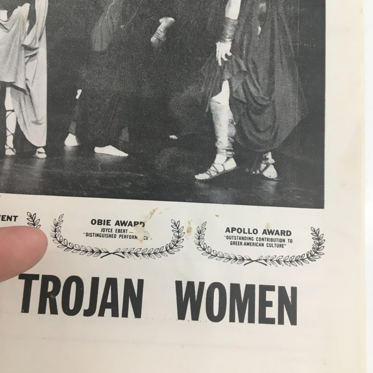 Close-up of the 1964 Showcard for 'The Trojan Women' highlighting awards like the Obie and Apollo.