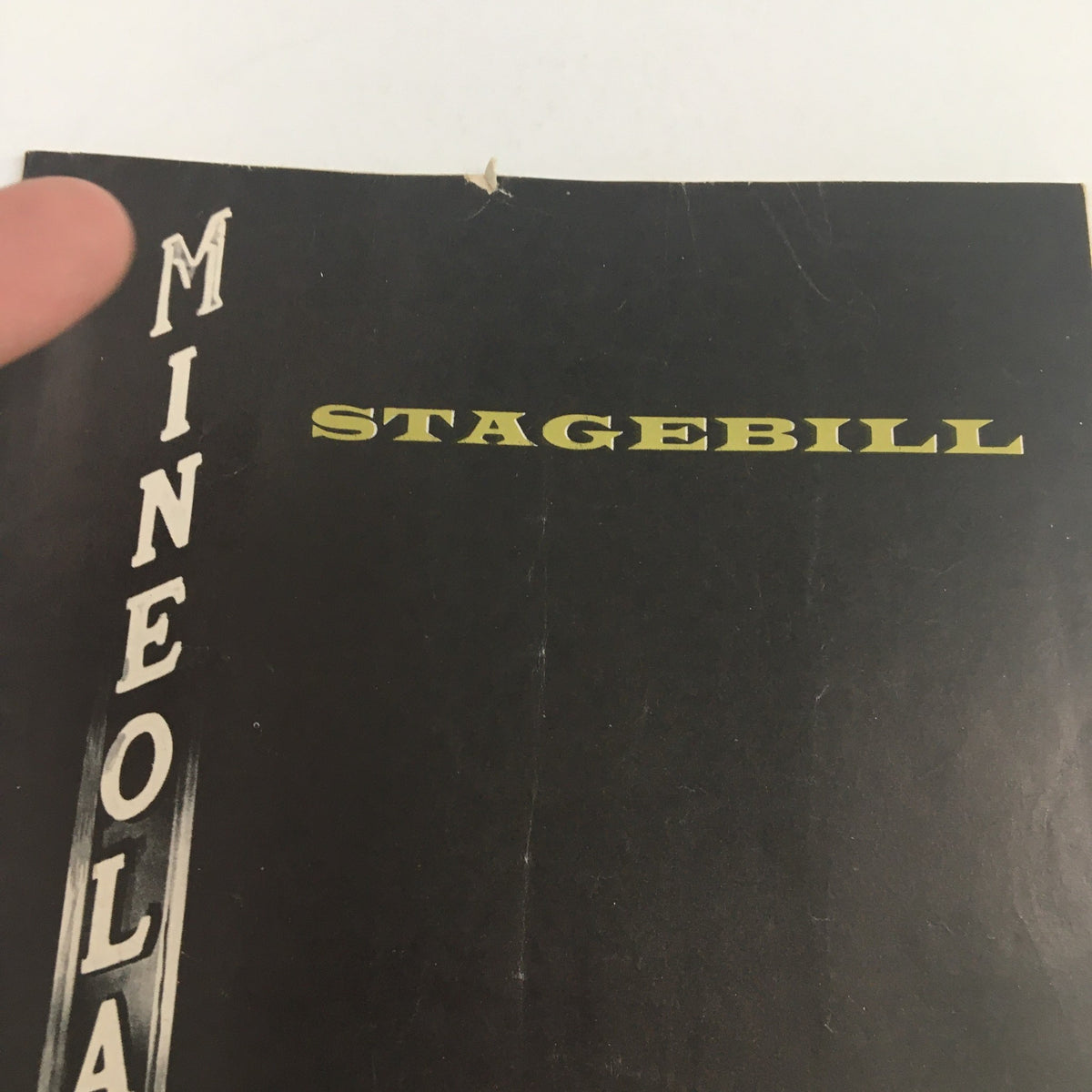 Close-up view of the 1963 Mineola Playhouse Stagebill cover highlighting its title and nostalgic design, part of the play 'The Irregular Verb To Love' by Cyril R. Ritchard.