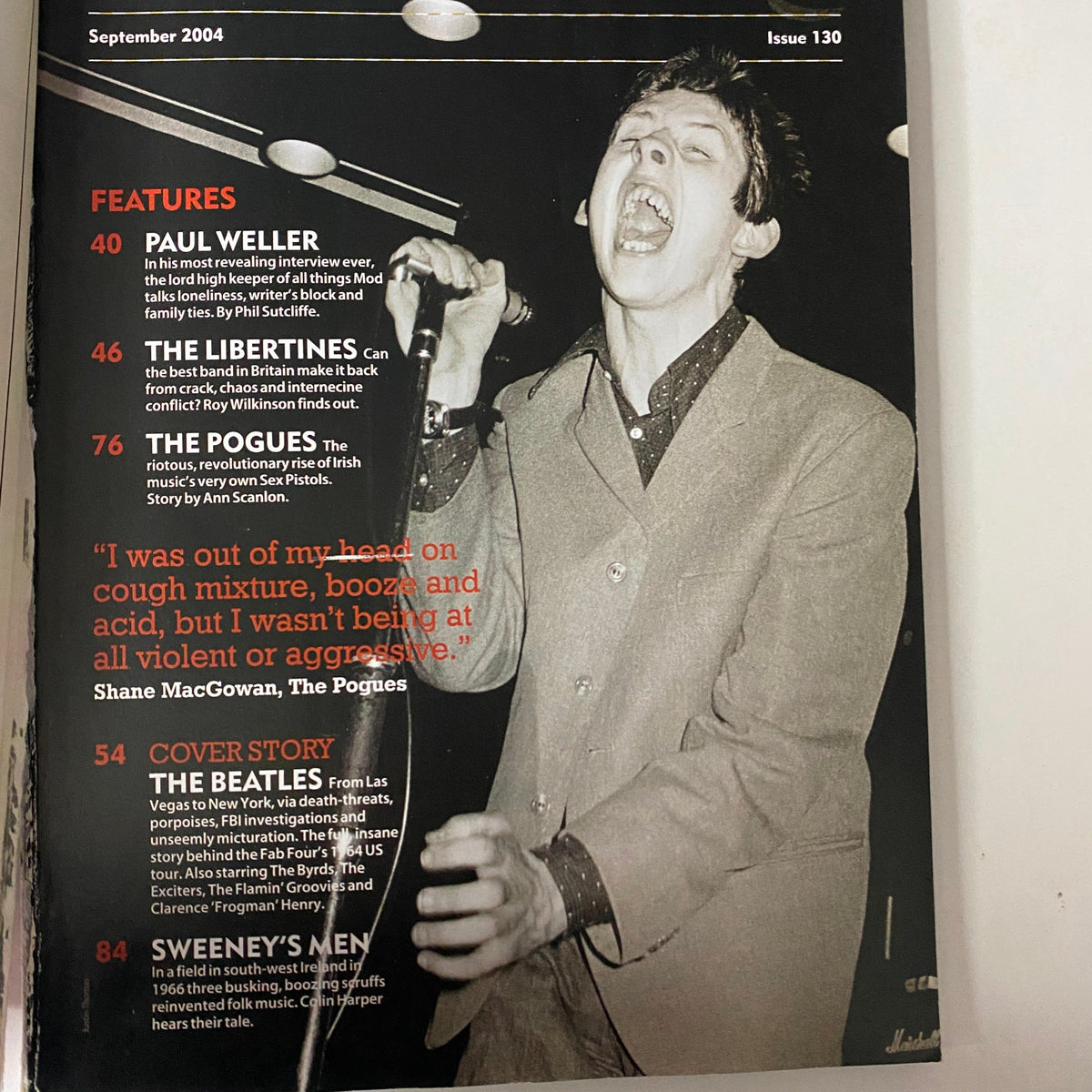 Inside pages of Mojo Music Magazine September 2004 highlighting features including Paul Weller and The Pogues, with singer Shane MacGowan captured passionately performing.