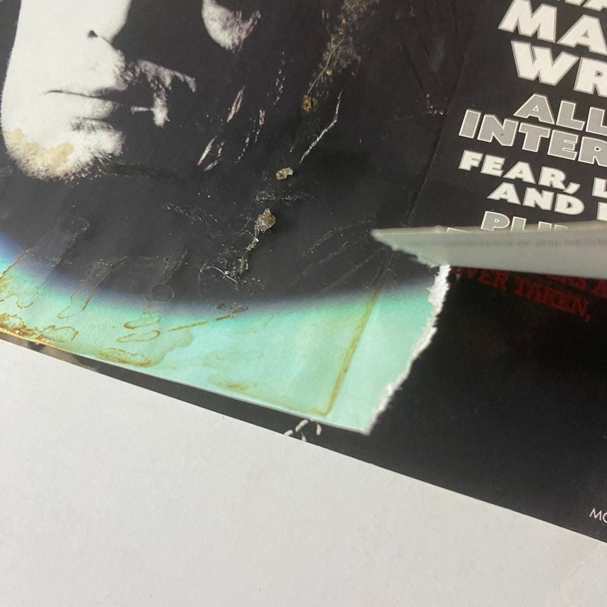 Close-up of the damaged edge of Mojo Music Magazine October 2007, revealing significant wear and tear on the cover.
