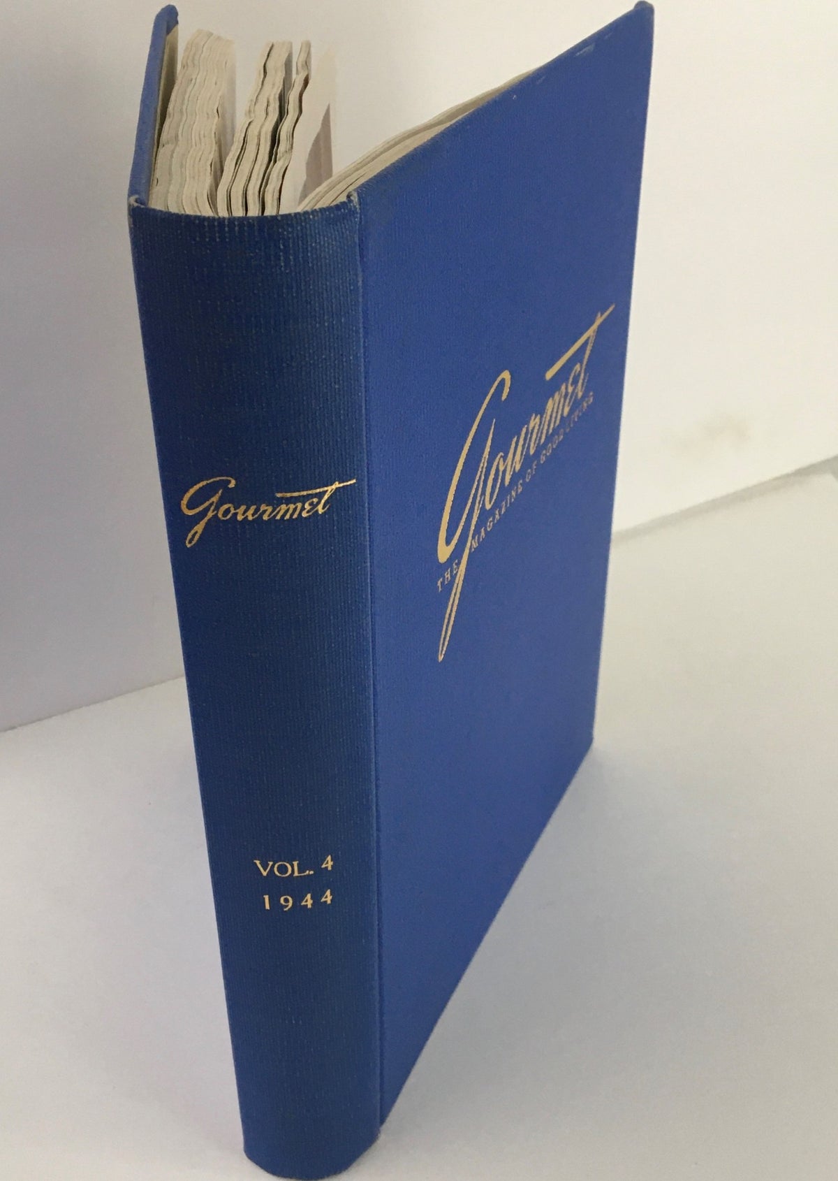 Gourmet The Magazine of Good Living, Vol 4, January to December 1944, showing the side view of the blue hardcover binding with gold lettering.