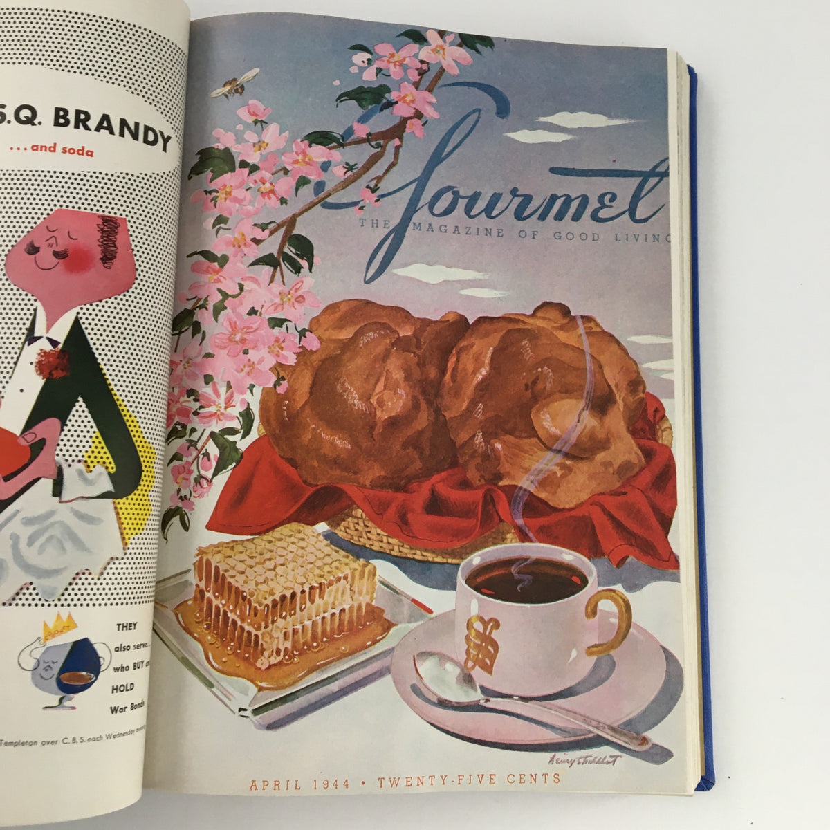 Cover illustration of Gourmet: The Magazine of Good Living, highlighting a basket of pastries and a cup of coffee surrounded by cherry blossoms from April 1944.