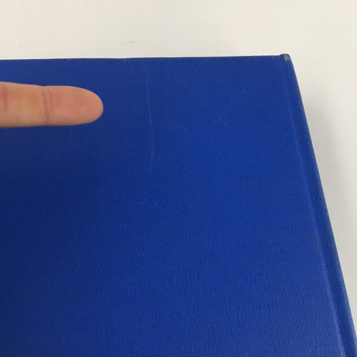 Detailed view of the spine of Gourmet: The Magazine of Good Living Vol 4 (January to December 1944), highlighting minor imperfections on the blue cover. A vintage collectible for culinary enthusiasts.