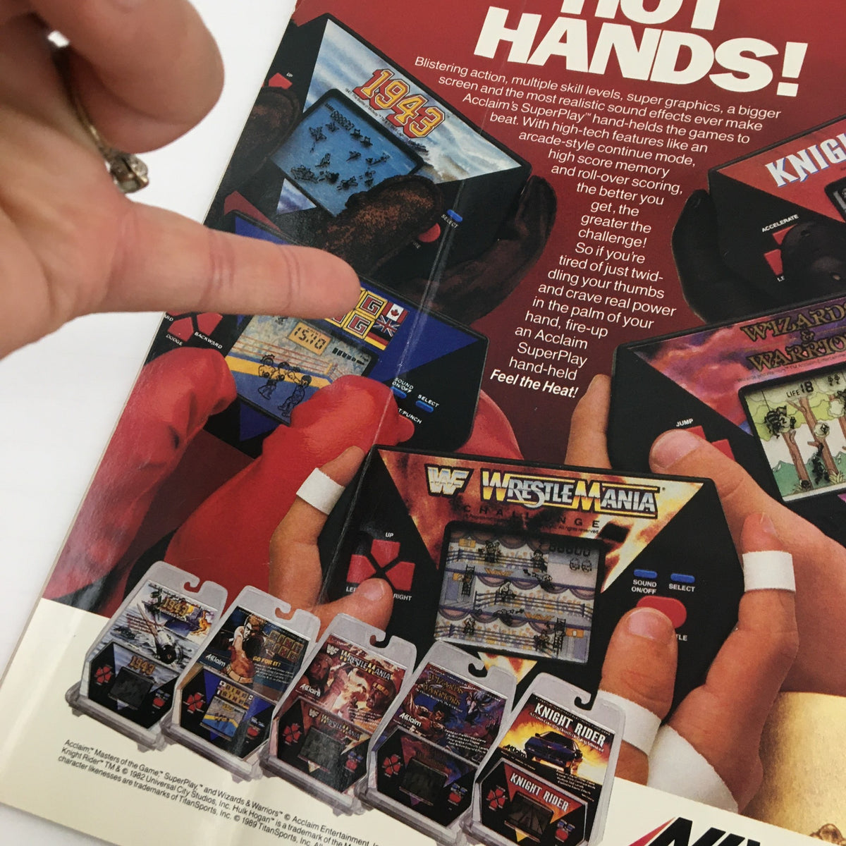 Close-up view of the back cover of WWF Magazine January 1990, showcasing an advertisement for Acclaim's wrestling video games. The image displays game titles like WrestleMania and Knights Rider, emphasizing excitement for wrestling gamers.