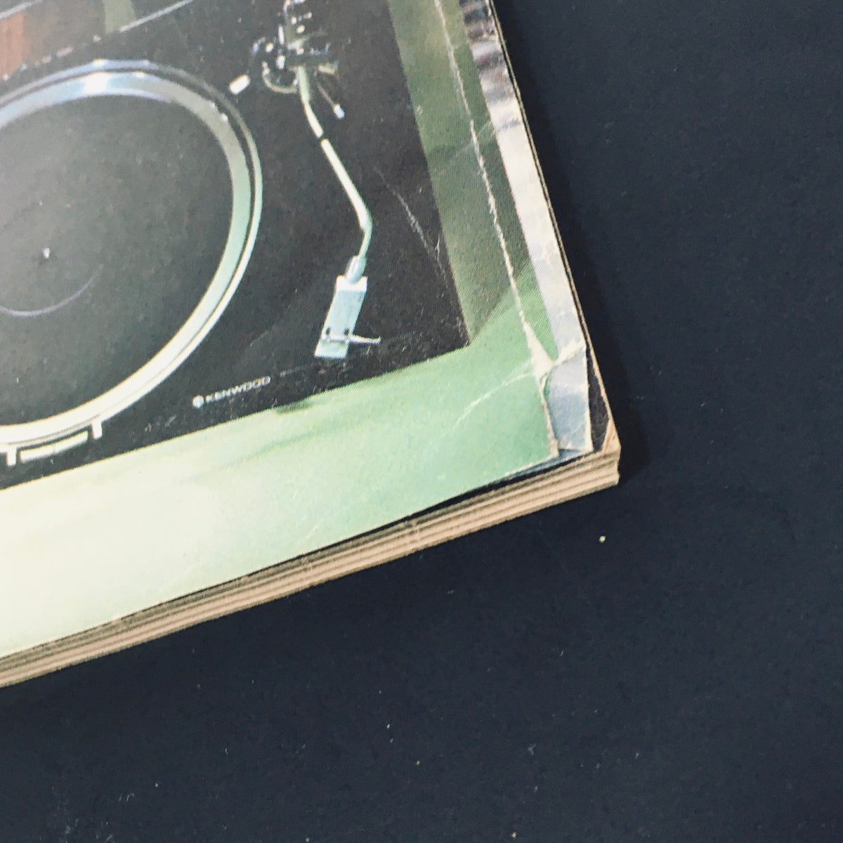 Close-up of the edge of High Fidelity Magazine April 1978, highlighting the vintage Kenwood turntable featured within the magazine, capturing the essence of audio technology from the late 1970s.