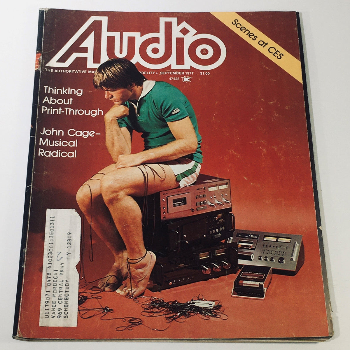 Cover of the September 1977 issue of High Fidelity Magazine featuring a young man surrounded by audio equipment, emphasizing John Cage as a musical radical.
