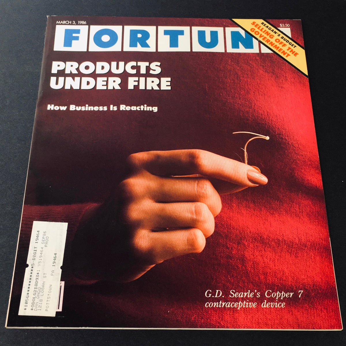 Cover of VTG Fortune Magazine dated March 3, 1986 featuring a hand holding G.D. Searle's Copper 7 contraceptive device, with bold text reading 'PRODUCTS UNDER FIRE'.