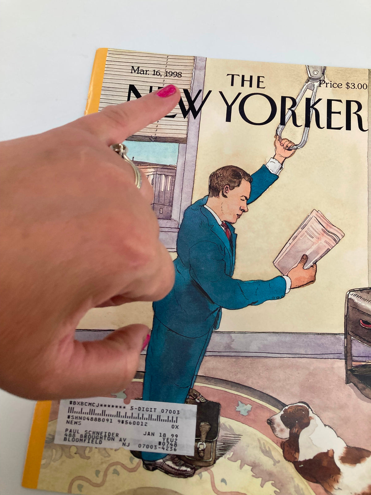 COVER ONLY The New Yorker March 16 1998 The Commuter by Barry Blitt, showcasing a finger pointing at the date and title on the magazine cover, with an illustration depicting a commuter and a dog.