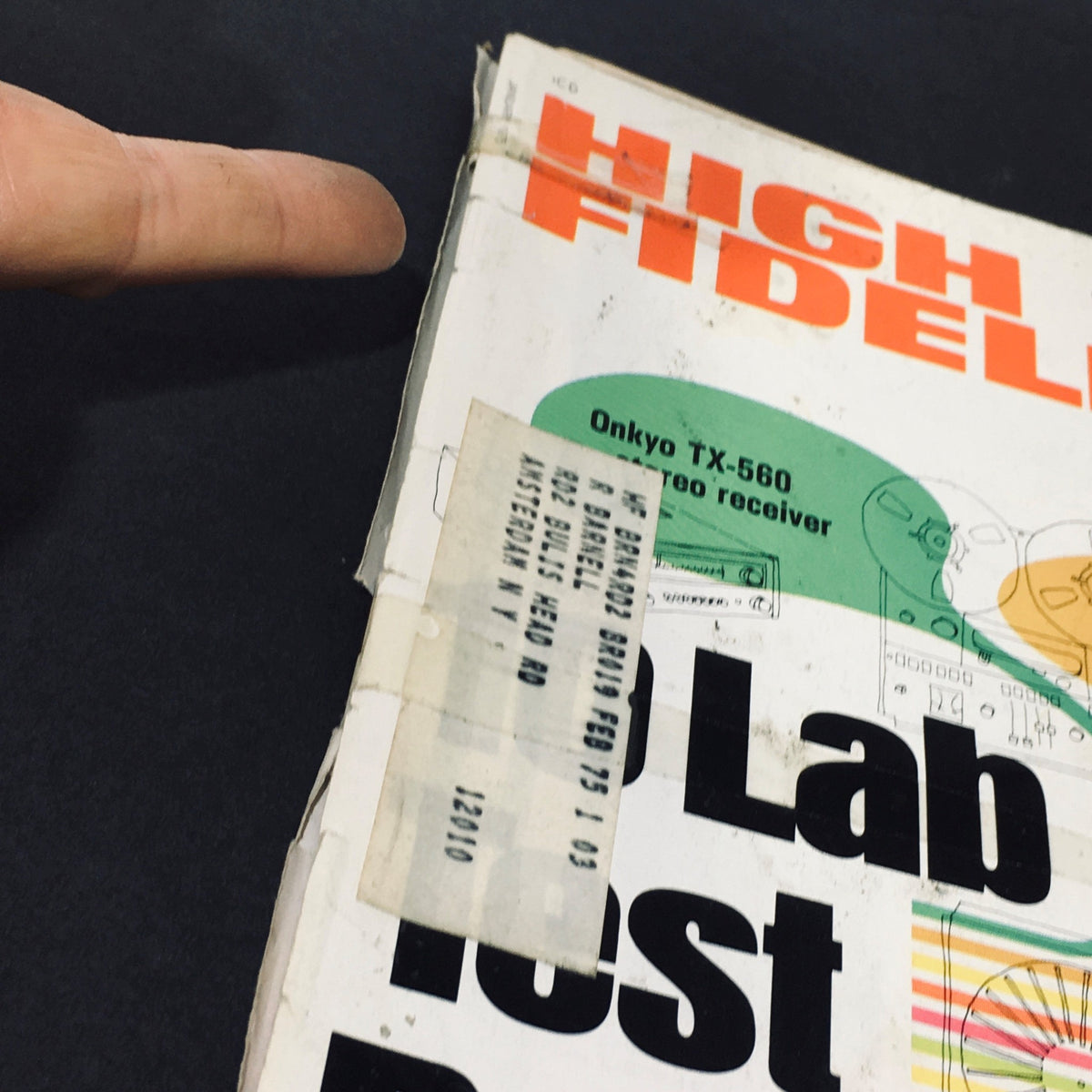 Detail of the spine of High Fidelity Magazine January 1975, highlighting an address label and showcasing its vintage wear.