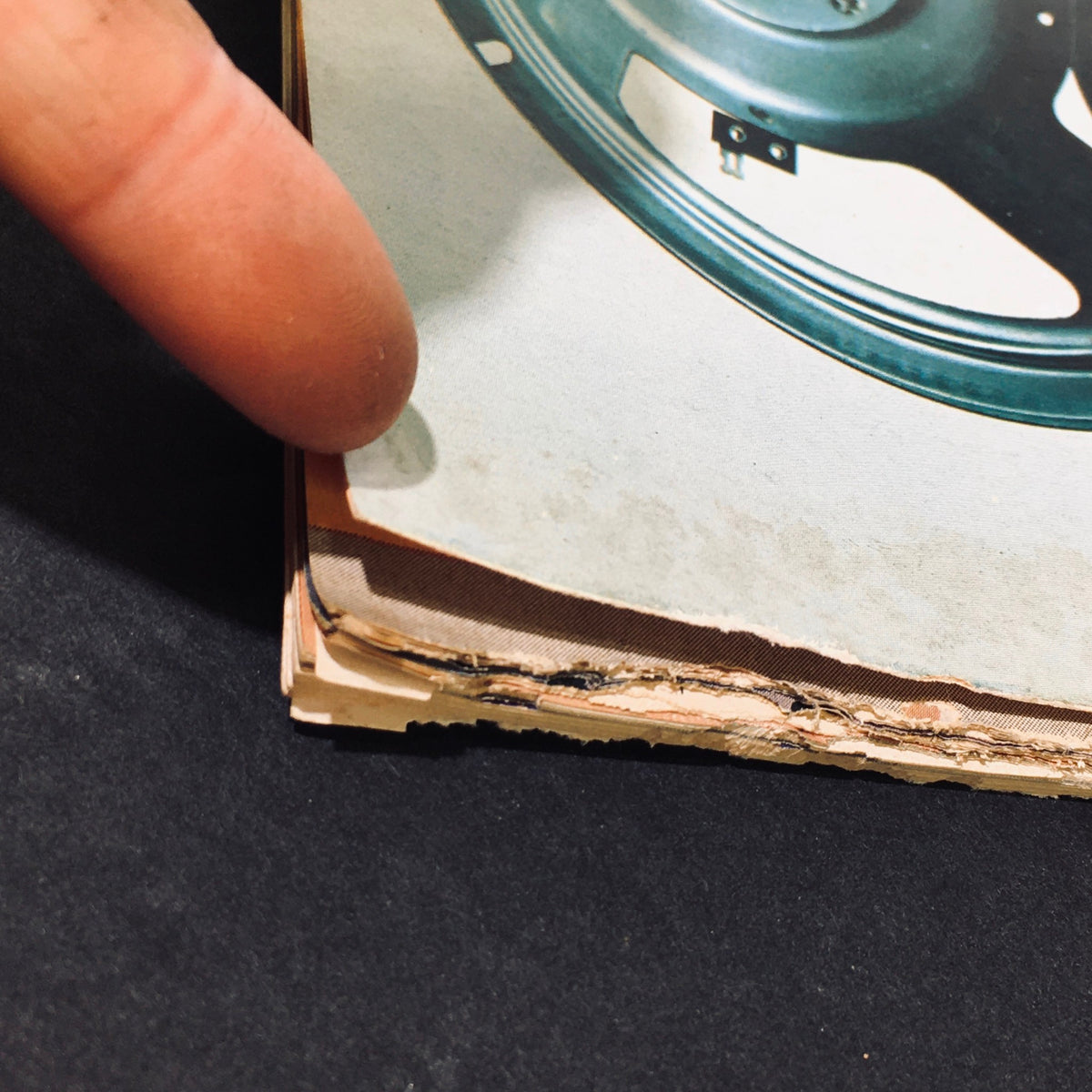 Close-up view of the edge of the Vintage Stereo Review Magazine August 1975, showcasing the typical wear and tear, including rips and a protective covering, relevant to its historical significance in buying and installing speakers.
