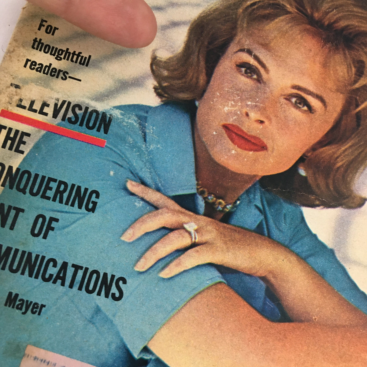 Detailed view of the July 21, 1962 cover of TV Guide Magazine highlighting the article 'The Conquering Giant of Communications' with visible wear and a woman's portrait.