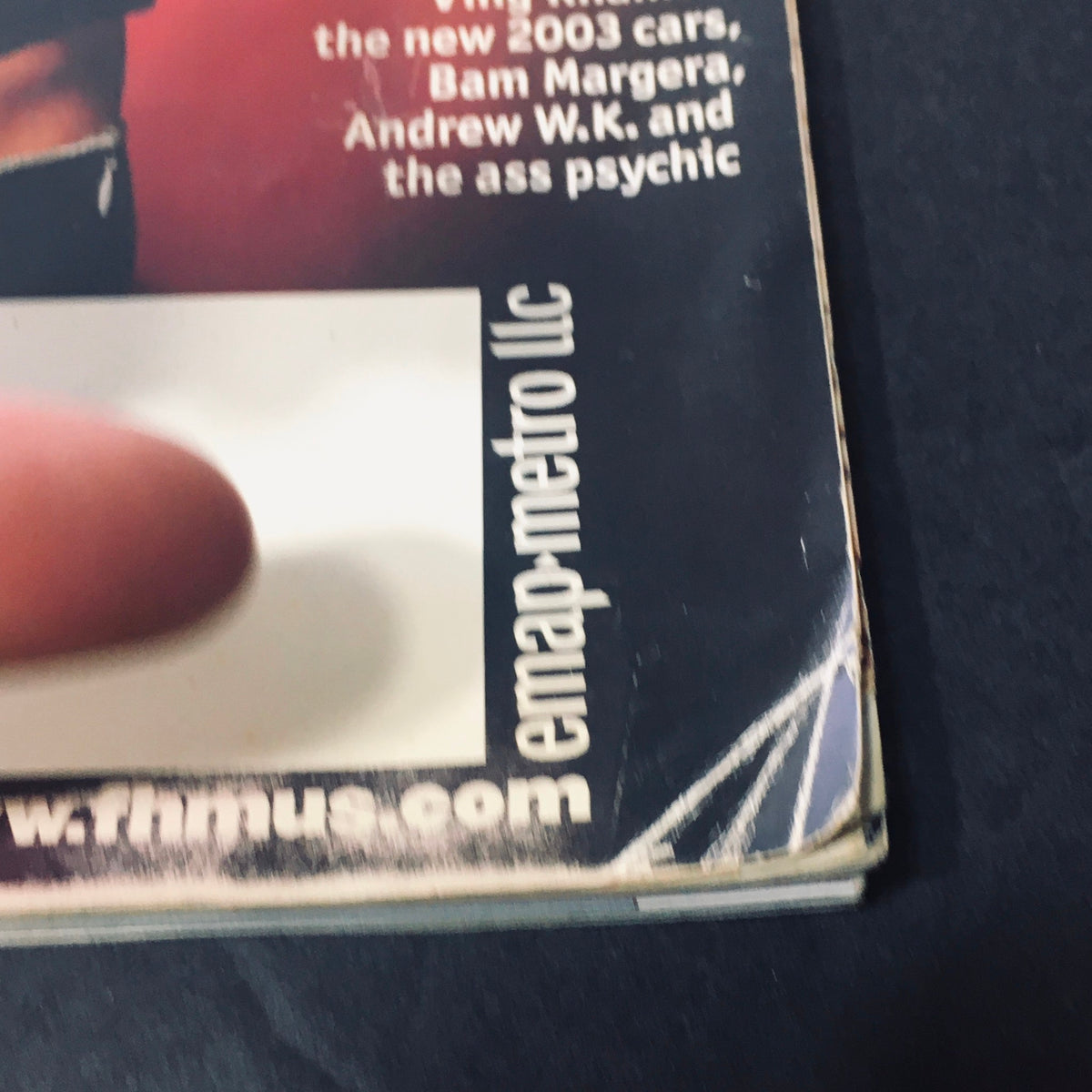 Cover of FHM Magazine November 2002 featuring Alyssa Milano with a finger pointing towards the text. The magazine includes features on new cars and celebrities like Bam Margera and Andrew W.K.