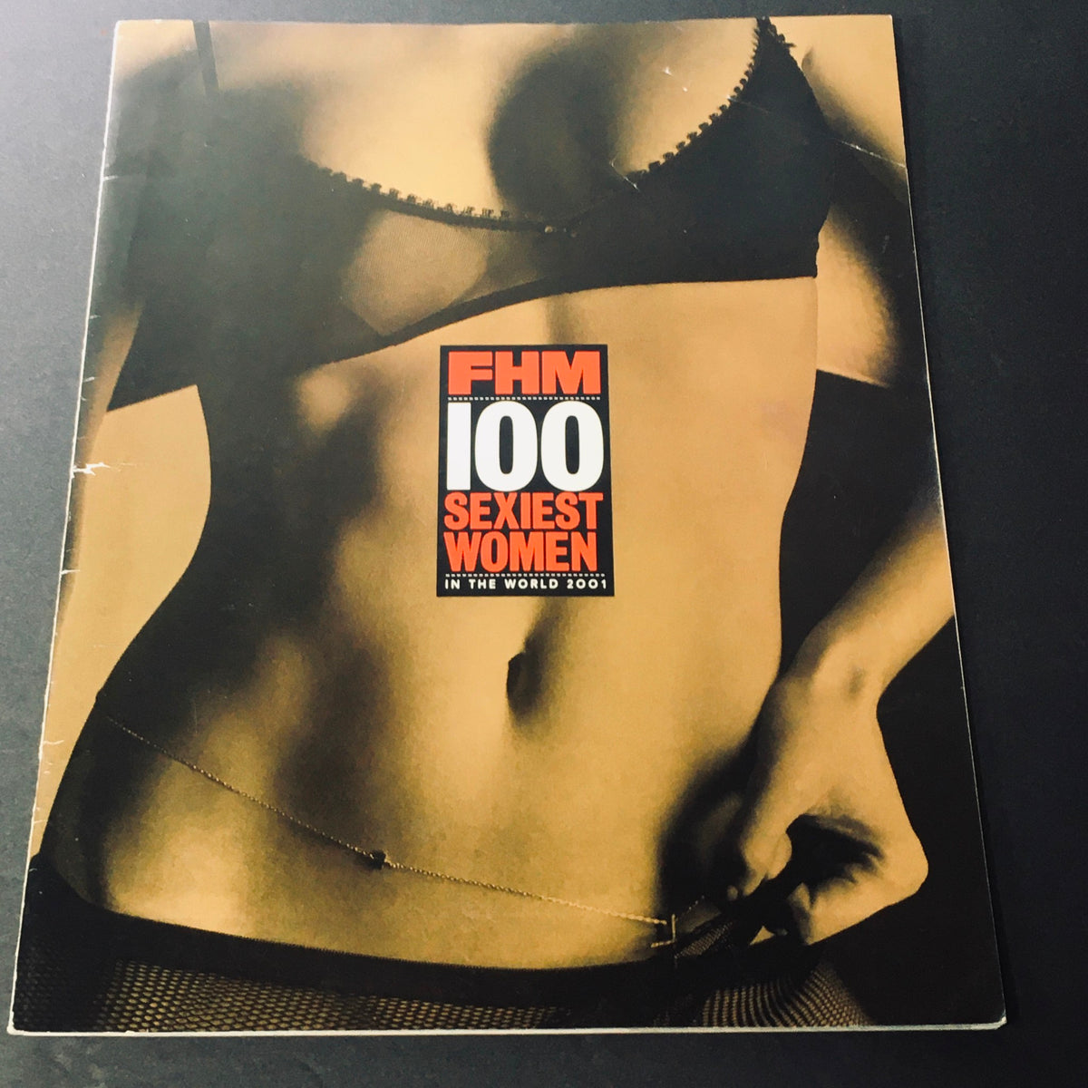 FHM Magazine 2001 cover featuring the title '100 Sexiest Women in the World 2001', showcasing a stylized photograph of a woman's midsection in lingerie.