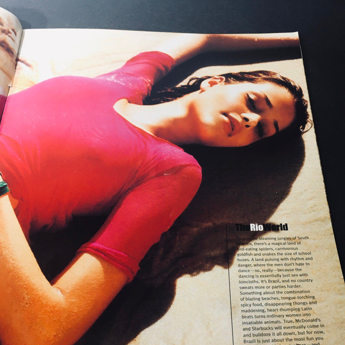 Inside page of Stuff For Him Magazine 2001 showcasing a model lounging in a pink top on the beach, representing the sun-kissed glamour of Brazilian supermodels.